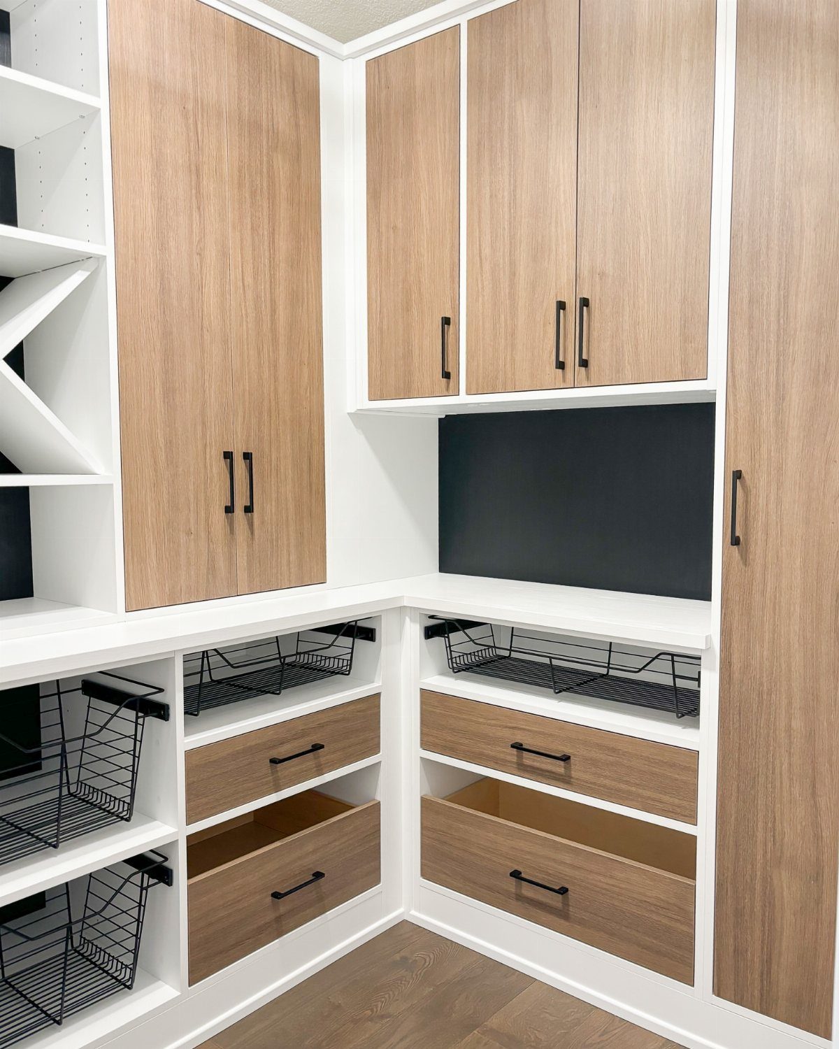 32 Simply Kitchen Design Ideas for a Clean, Modern Space 32 White and wood grain pantry with pull-out baskets and deep storage drawers.