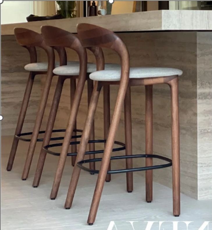 Wood Art Furniture: 31 Ideas From Rustic to Sculptural Forms 5 Three curved wooden bar stools with light seats tucked under a wooden counter.