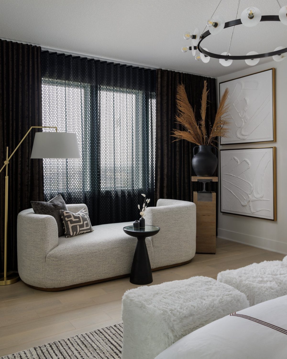 Master Bedroom Interior Design: 16 Ideas for a Better Space 6 Curved cream chaise lounge with a black side table in a modern bedroom