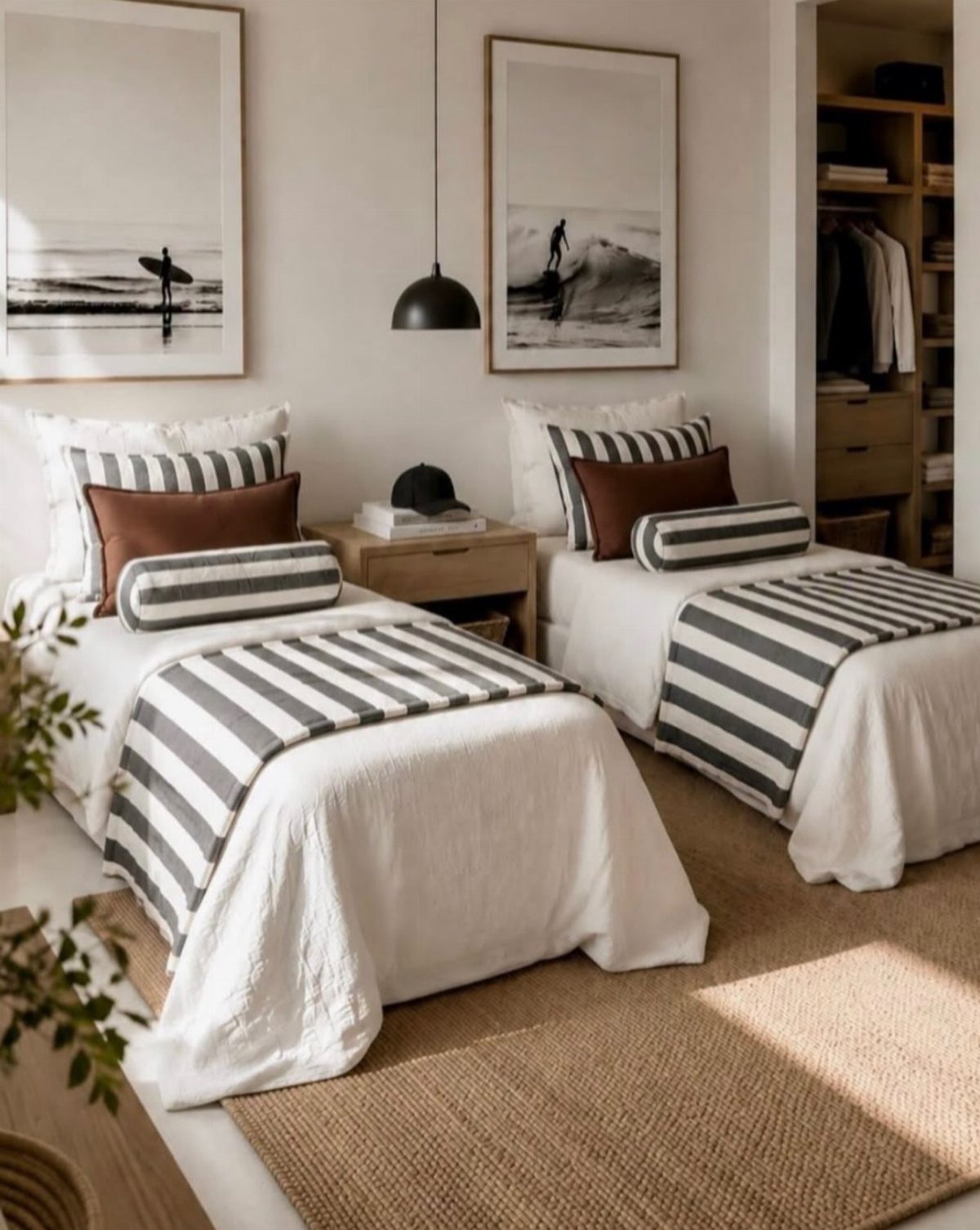 Two twin beds with white bedding and striped runners in a bright bedroom.