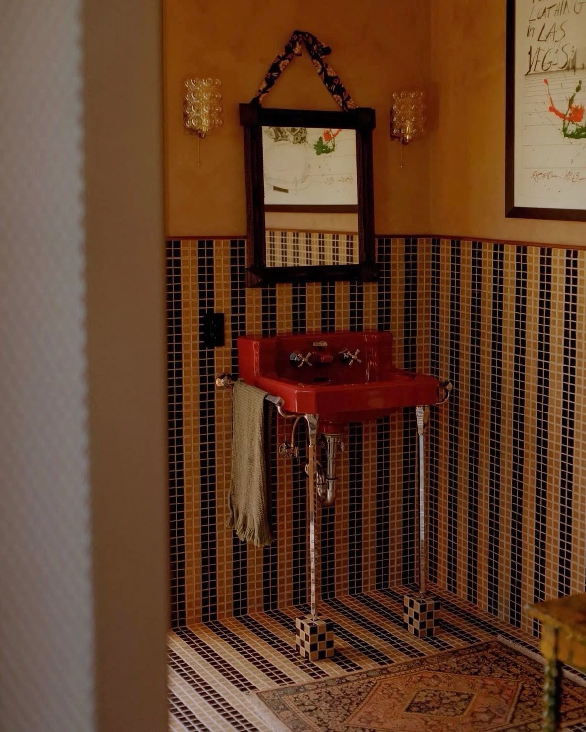 Black Mosaic Tile Bathroom: 14 Designs from Hex to Herringbone 15 Red pedestal sink in a bathroom with black and gold mosaic tile walls.