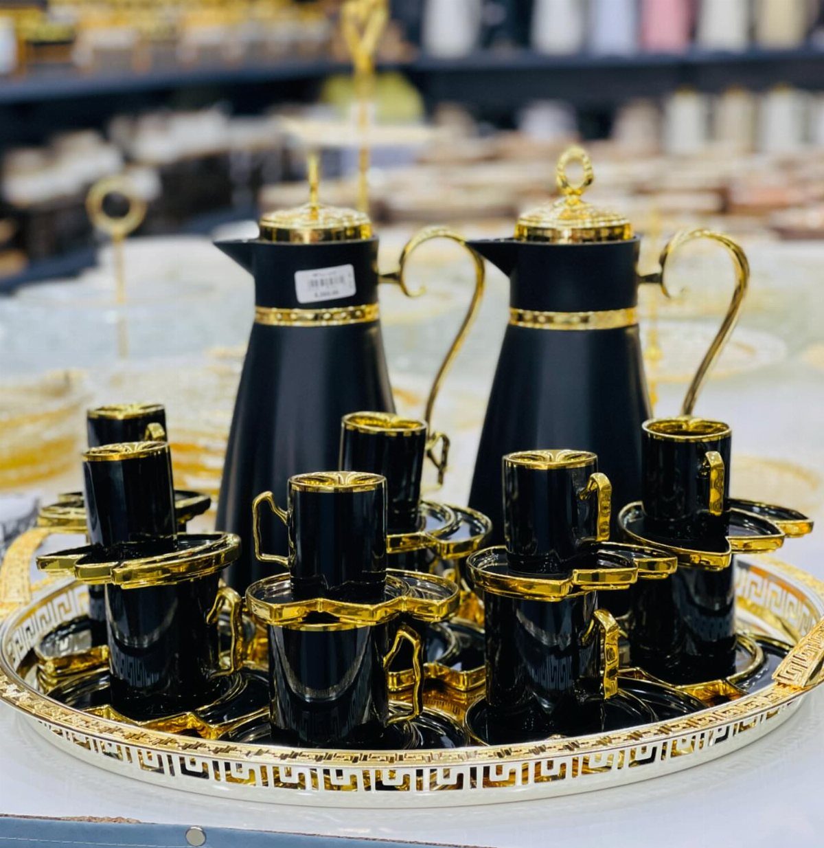 Gothic Tea Set: 24 Dark & Elegant Serving Ideas 2 Black and gold tea set with carafes and cups on a decorative tray.