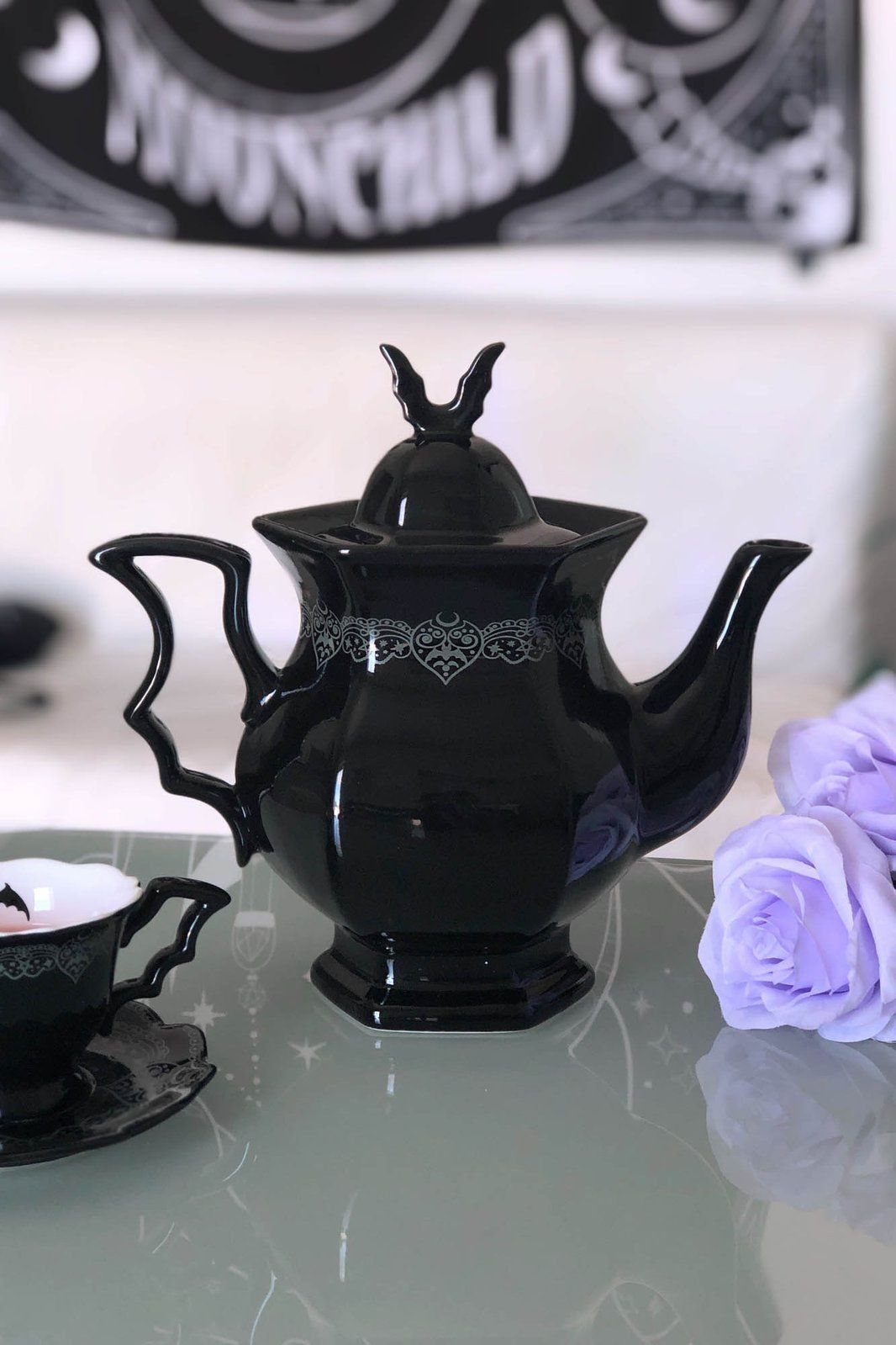 Gothic Tea Set: 24 Dark & Elegant Serving Ideas 14 Black porcelain teapot and teacup with silver filigree on a tray with purple roses