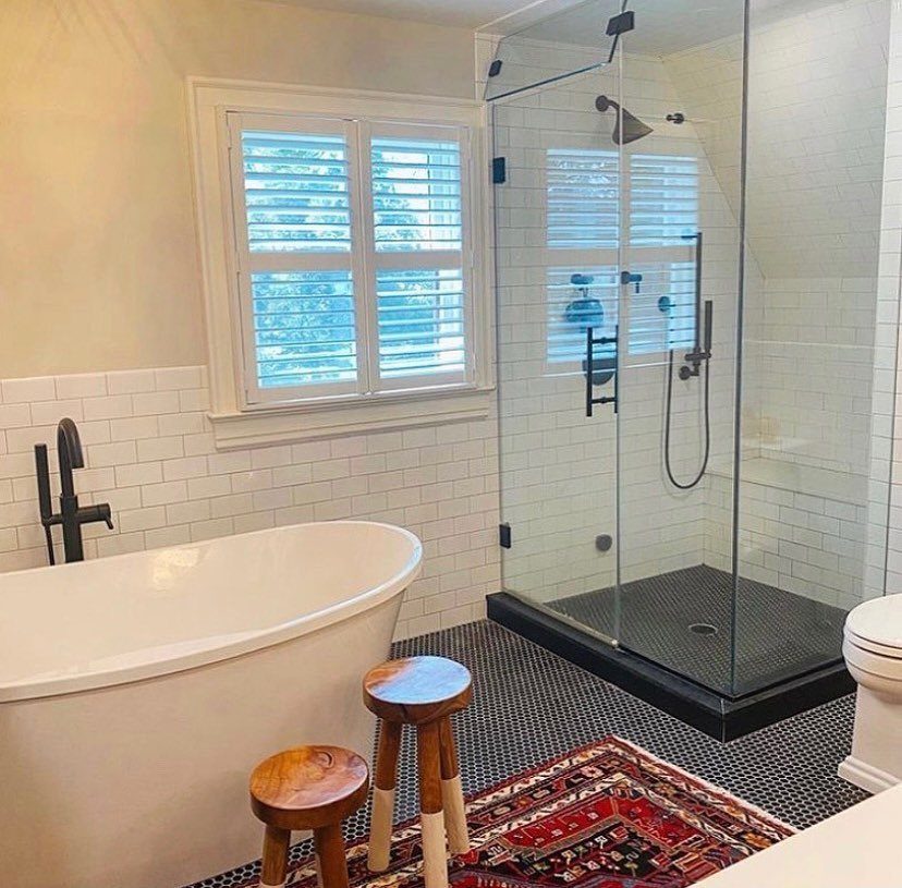Black Mosaic Tile Bathroom: 14 Designs from Hex to Herringbone 14 Bathroom with black mosaic tile floors, white bathtub, and glass walk-in shower.
