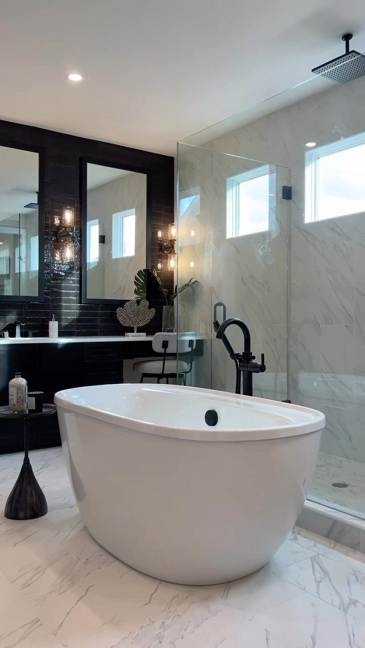 Black Mosaic Tile Bathroom: 14 Designs from Hex to Herringbone 3 White freestanding bathtub in a bathroom with black subway tile walls and marble shower.