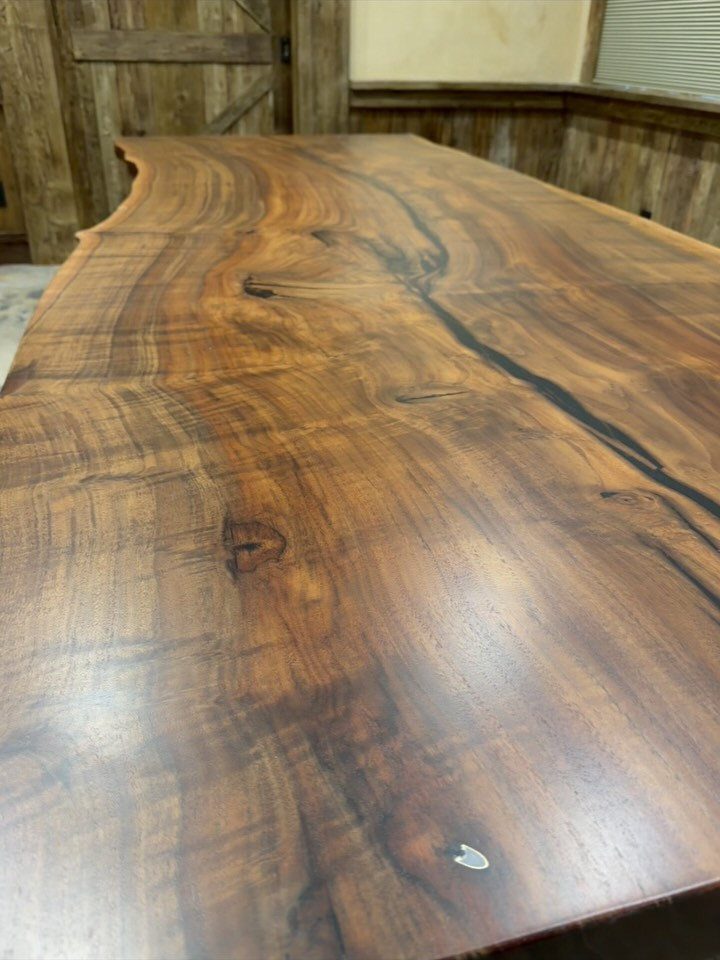 Live Wood Furniture in 31 Styles, from River Tables to Desks 5 Polished black walnut table surface with a natural live edge and rich grain.