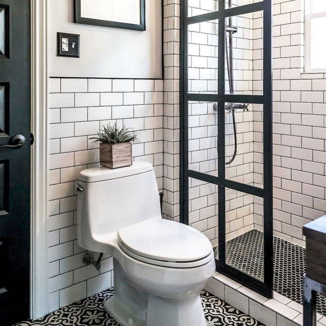 Black Mosaic Tile Bathroom: 14 Designs from Hex to Herringbone 9 Bathroom with white subway tiles, white toilet, and black mosaic tile flooring.