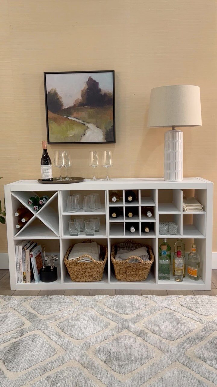 13 Cube Organizer Ideas for Your Living Room Layout 6 White cube organizer home bar with wine bottles, glassware, and wicker baskets.