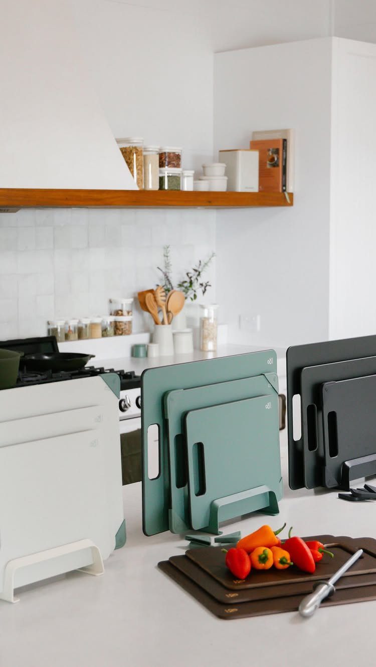 Small Kitchen Essentials: 13 Tools That Actually Matter 2 Plastic cutting boards in various colors standing on a white kitchen countertop.
