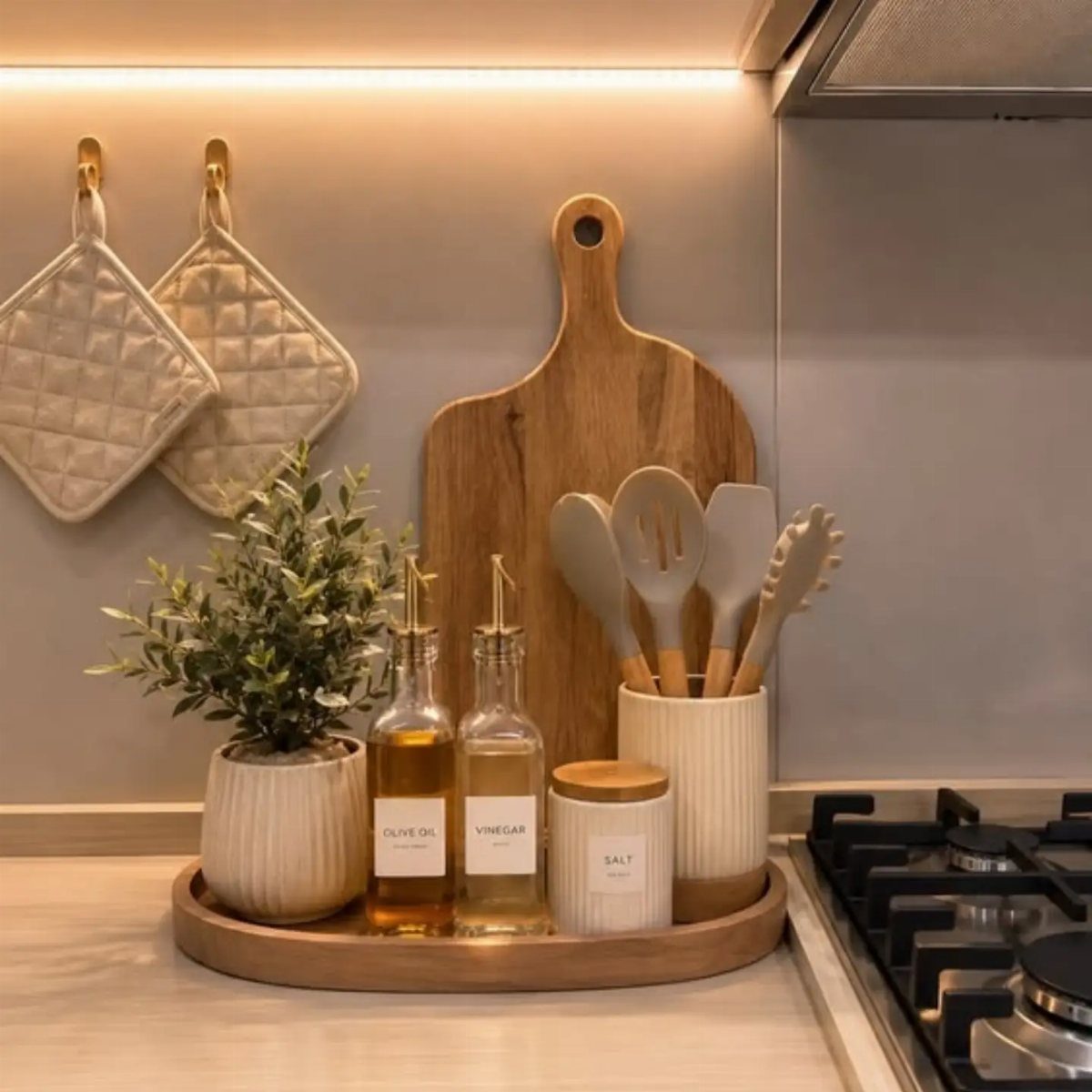 27 Small Kitchen with Fridge Ideas That Maximize Every Inch 12 Kitchen counter with wooden tray, oil bottles, potted plant, and hanging cutting board.