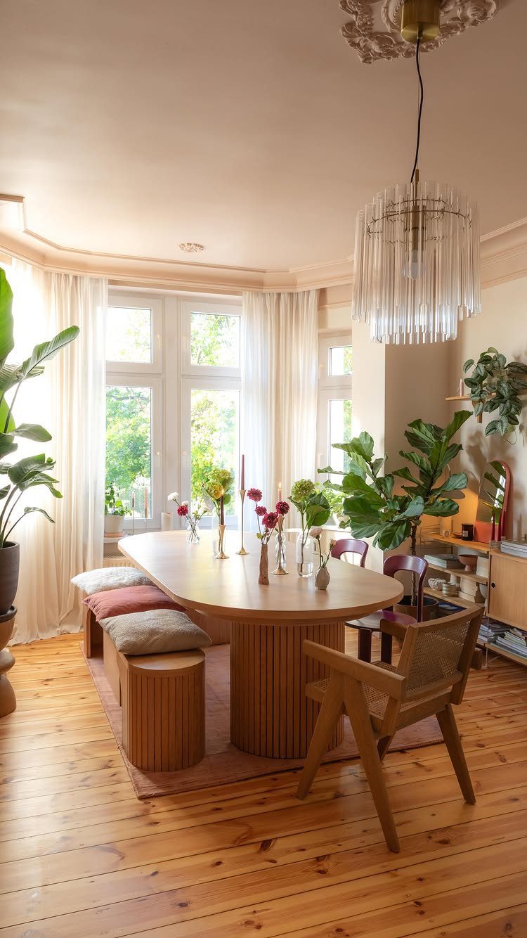 Wood Art Furniture: 31 Ideas From Rustic to Sculptural Forms 4 Oval wooden dining table with ribbed base in a bright room with plants.