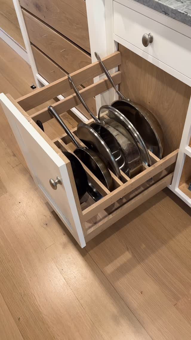 26 Pull Out Drawer Kitchen Ideas That Save Space 23 Pull-out kitchen drawer with stainless steel pans stored vertically in wooden dividers.