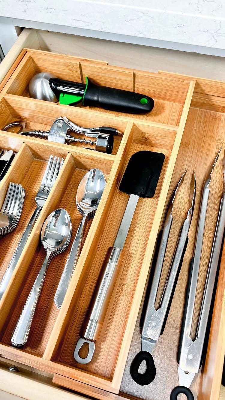 17 Ways to Organize Kitchen Tools (With Photos for Each) 2 Wooden drawer organizer holding sorted kitchen utensils like spoons, forks, and tongs.