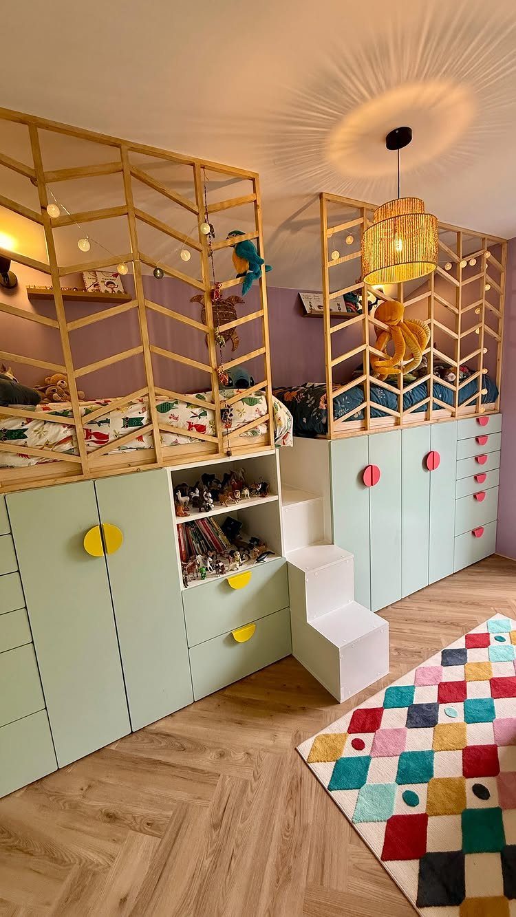 8 Ideas for a Bedroom with 2 Beds That Save Space 6 Two elevated beds with mint green storage cabinets underneath in a children's bedroom.
