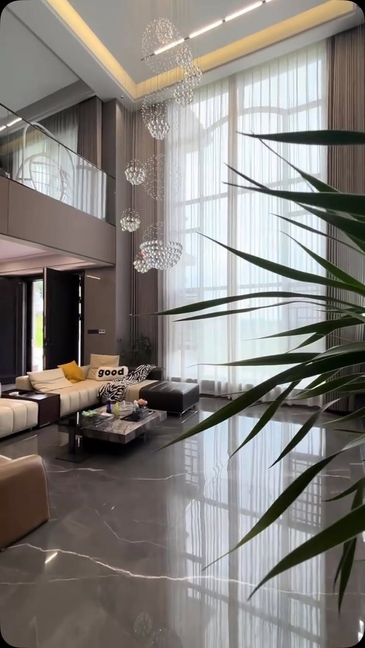27 Vibey Living Room Aesthetic Ideas Worth Copying 7 Modern living room with expansive floor-to-ceiling windows and polished marble floors.