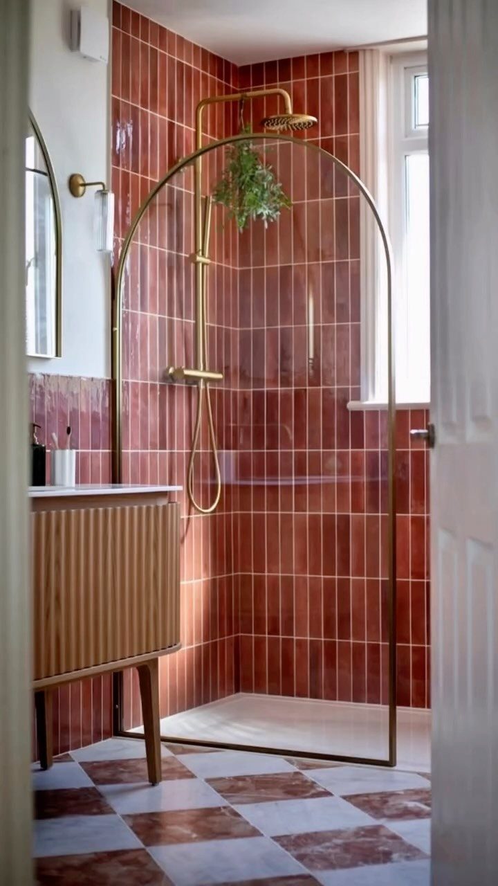 Bathroom Alcove Ideas: 29 Designs for Tubs, Showers & More 8 Glossy red tiled shower with a gold frame and checkered marble flooring.