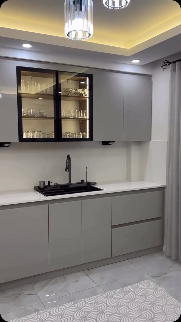 21 Kitchen Interior Colors for 2026 (White, Green & More) 7 Modern kitchen with light gray cabinets, white countertops, and gray marble tile flooring.