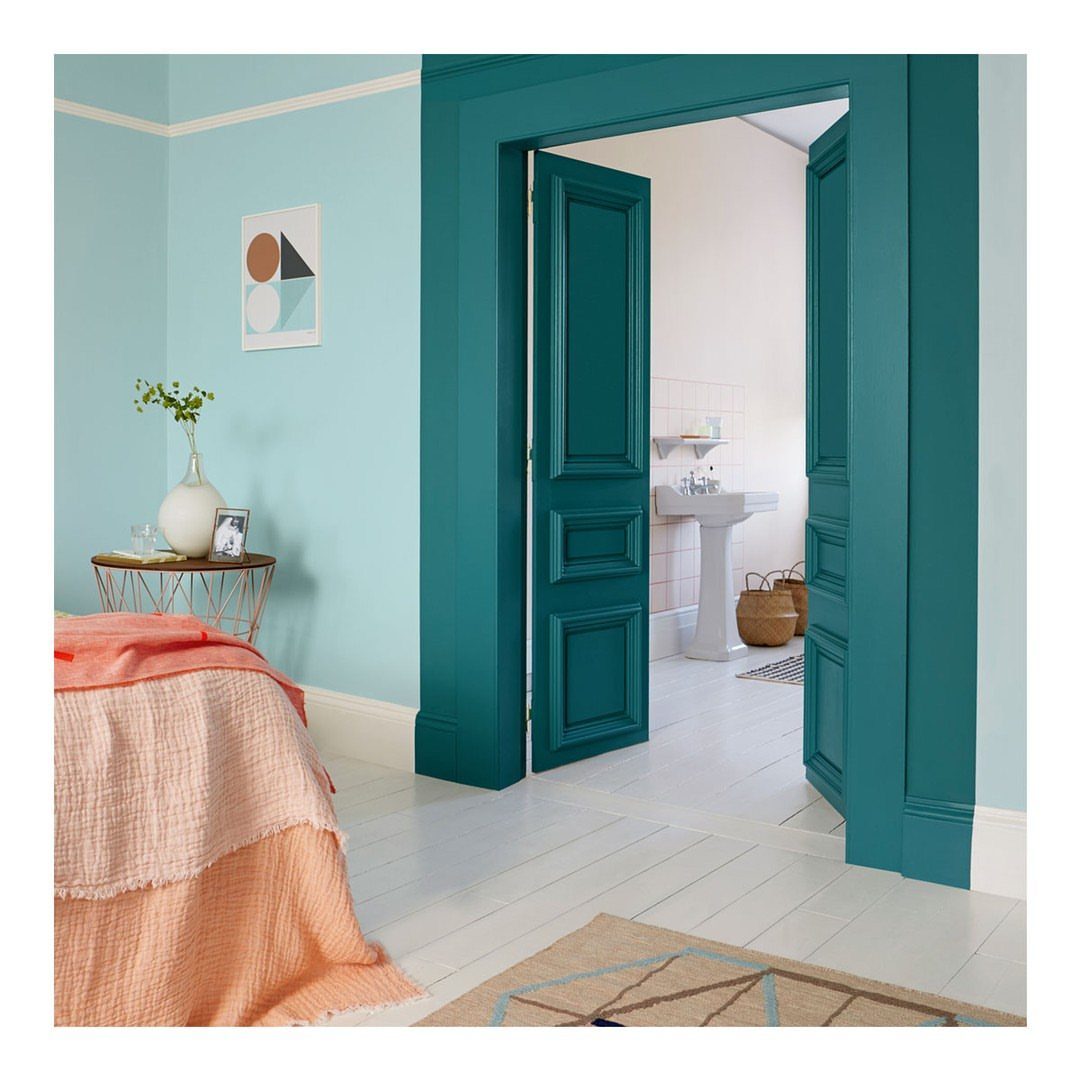 Master Bedroom Interior Design: 16 Ideas for a Better Space 5 Aqua blue bedroom walls with a contrasting dark teal door frame and peach bedding.