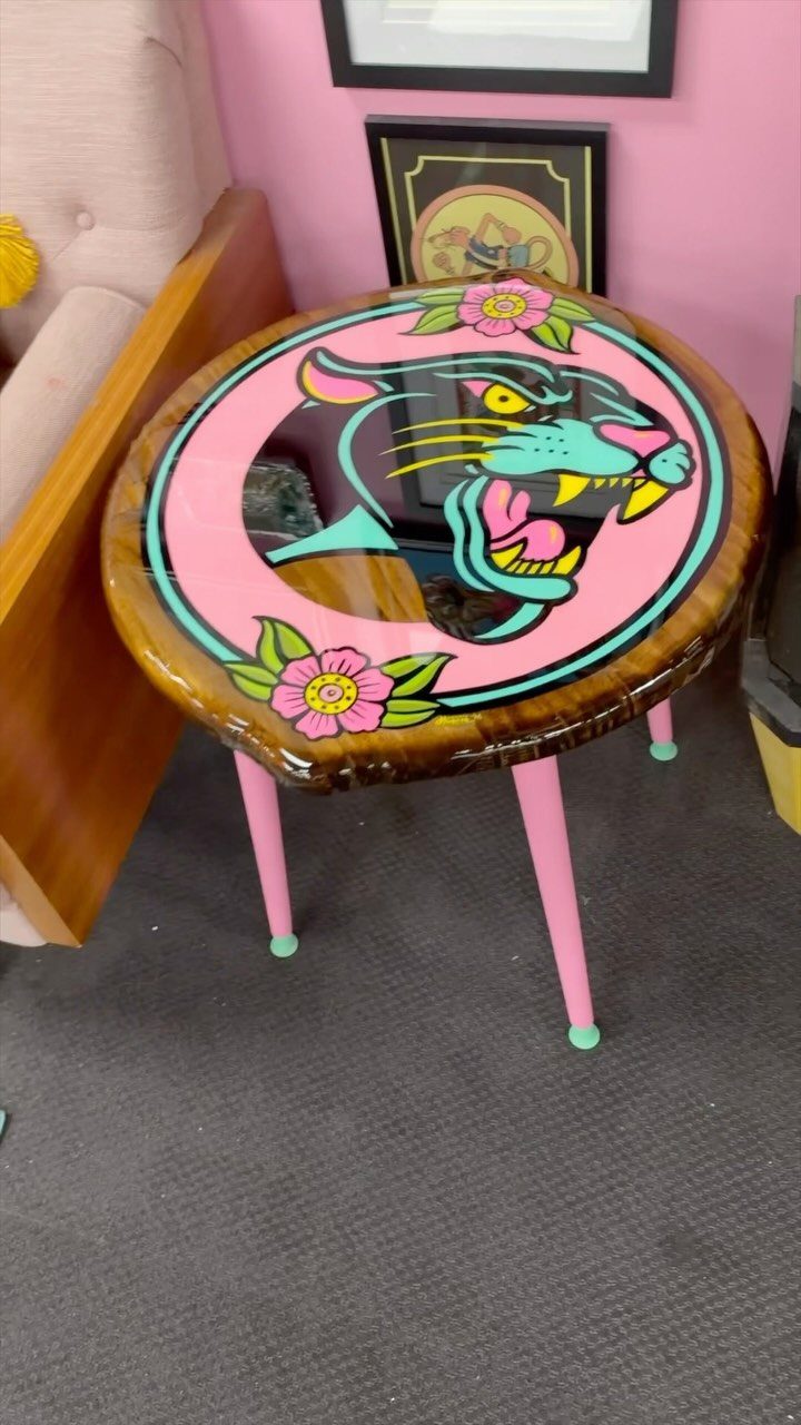 Wood Art Furniture: 31 Ideas From Rustic to Sculptural Forms 11 Round wooden table with a colorful painted panther head and pink legs.