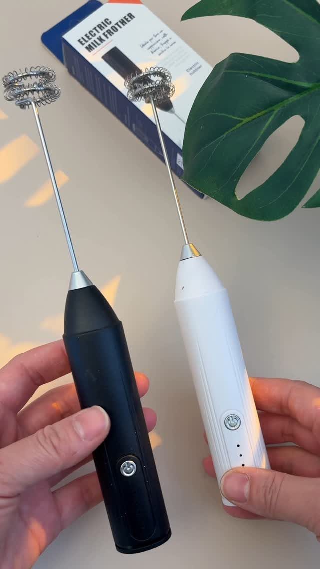 Black and white handheld milk frothers held by hands next to product packaging.