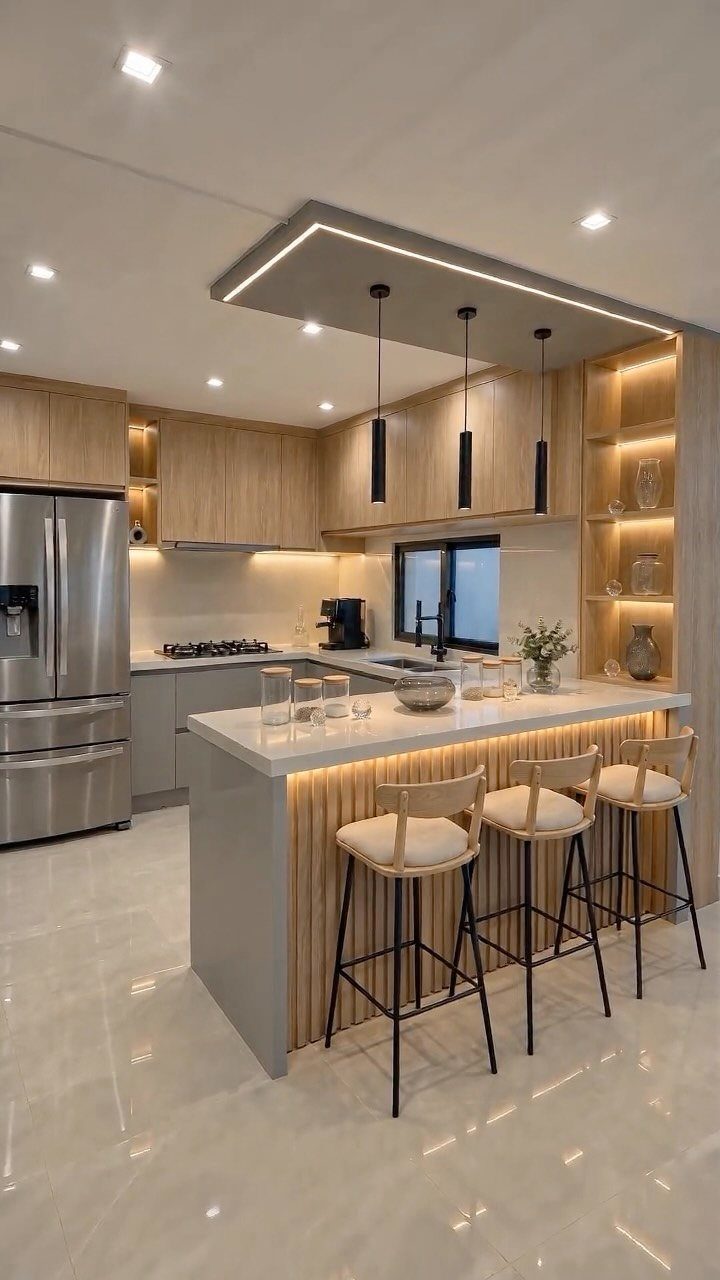 Modern kitchen with handleless wooden cabinets and a white dining island with barstools.