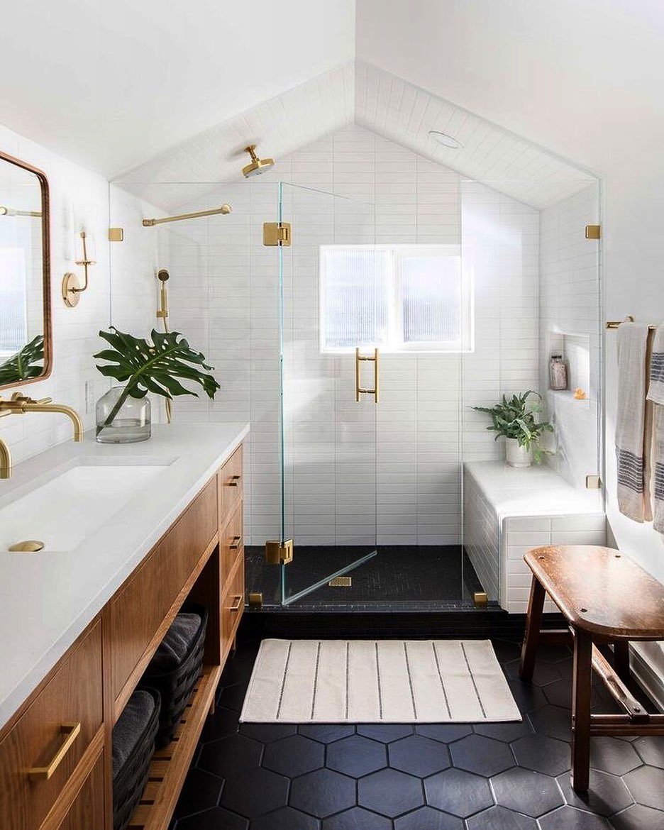Black Mosaic Tile Bathroom: 14 Designs from Hex to Herringbone 2 Black hexagon tile floor in a bright white bathroom with a glass shower.