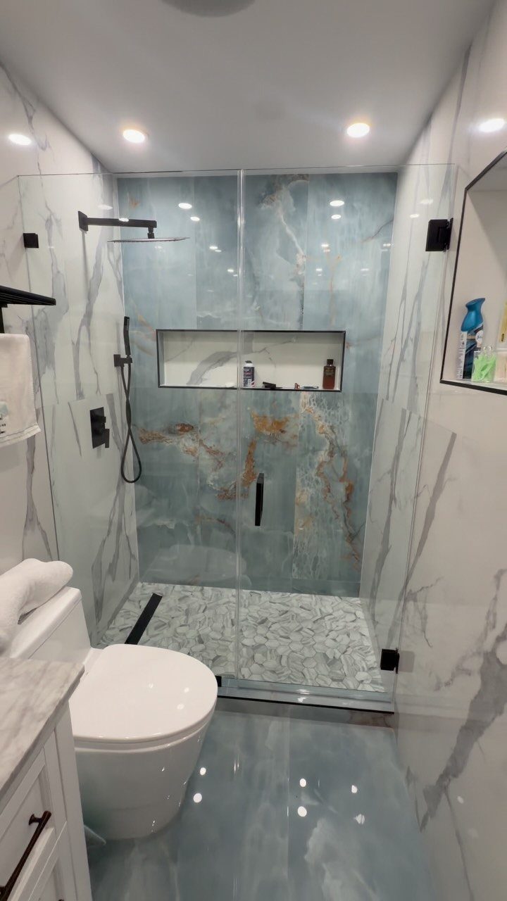 Bathroom Alcove Ideas: 29 Designs for Tubs, Showers & More 7 Modern bathroom with blue marble-style shower walls, glass door, and integrated wall niche.
