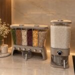 Plastic kitchen storage containers filled with colorful grains and rice on a marble counter