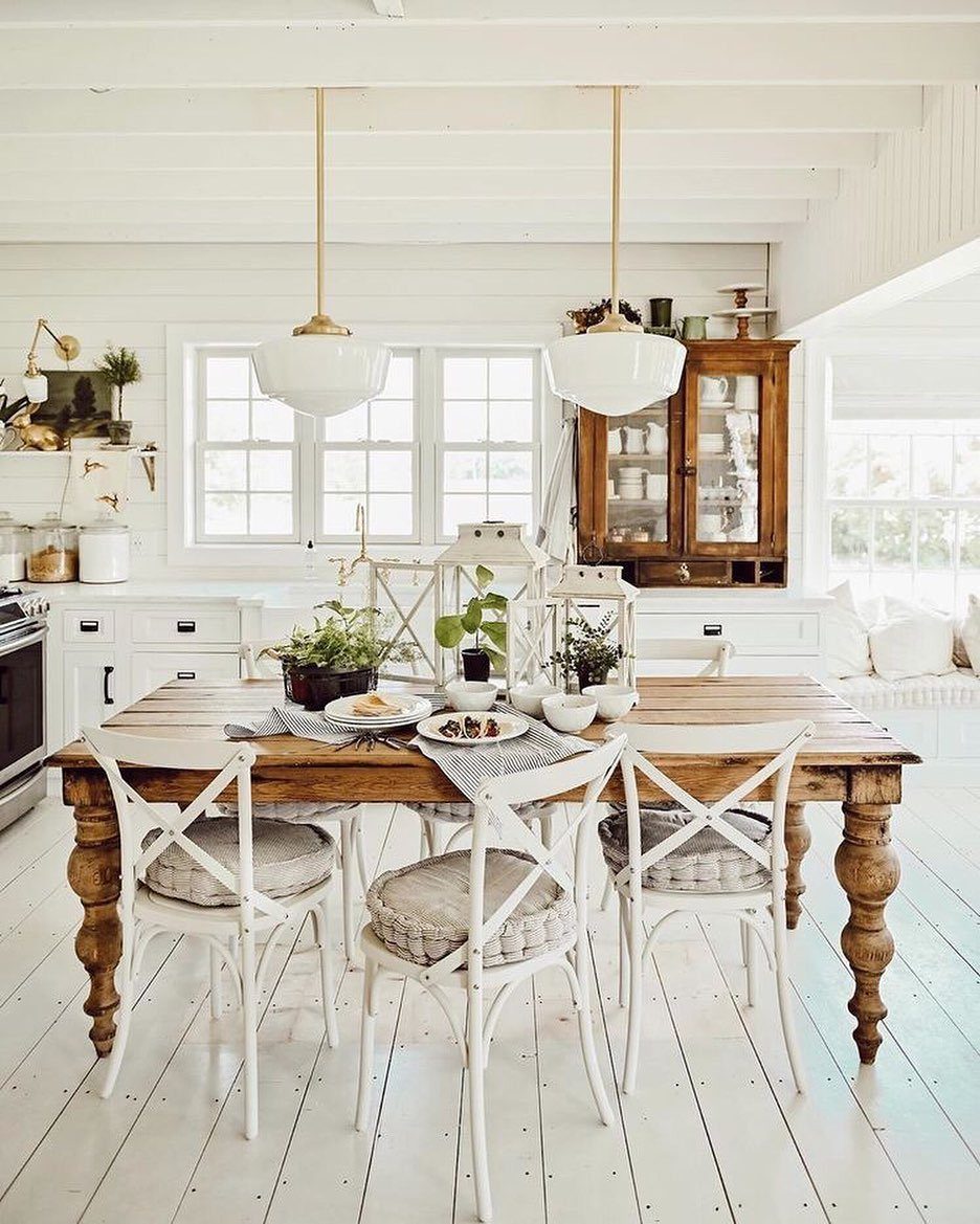 20 French Farmhouse Dining Table Ideas for Every Style 3 Rustic wooden dining table with turned legs and white cross-back chairs in bright kitchen