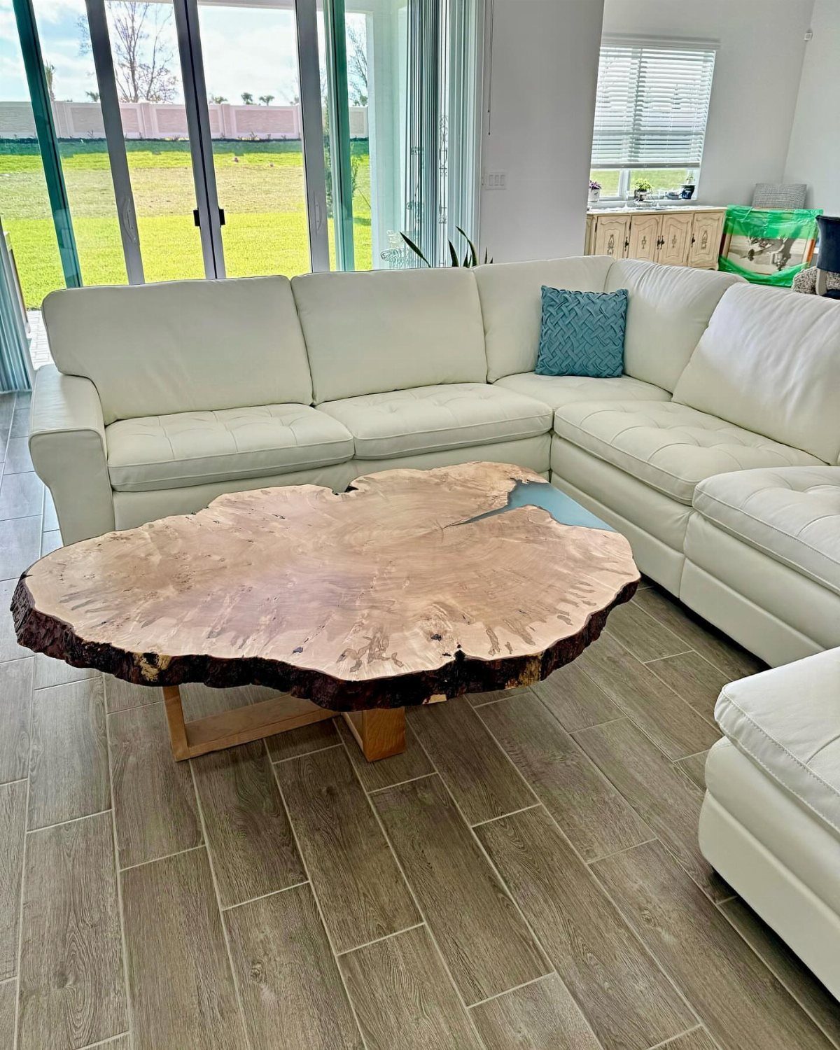 Live Wood Furniture in 31 Styles, from River Tables to Desks 3 Live edge wood slab coffee table with blue resin inlay in a modern living room.