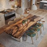 Live wood dining table with natural edges and green chairs in a modern kitchen.