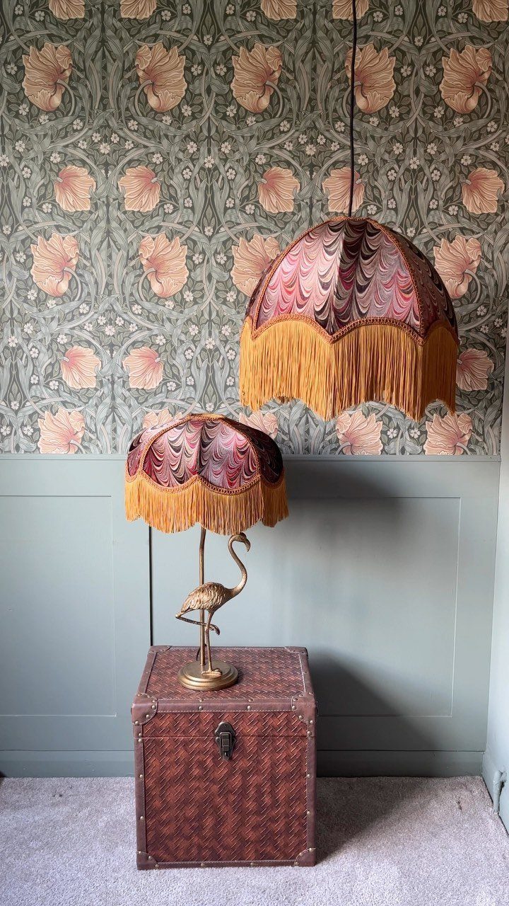 27 Vibey Living Room Aesthetic Ideas Worth Copying 23 Matching fringed red lamps and floral wallpaper in a vintage styled living room corner.