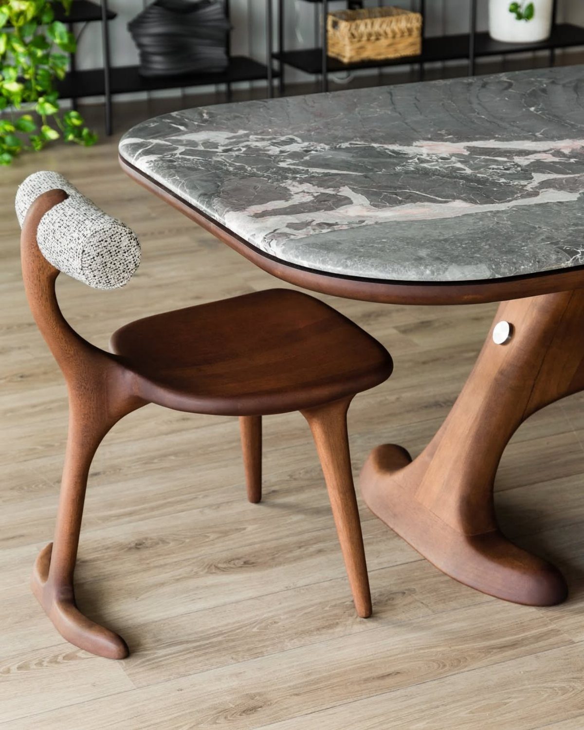 Contemporary Dining Sets in 12 Styles for Your Space 10 Marble dining table with a sculptural wooden base and a matching wooden chair.