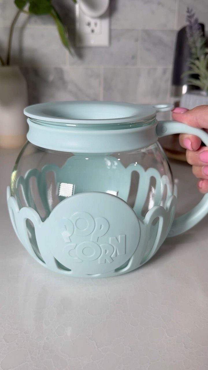 Light blue microwave popcorn popper bowl with glass center and silicone handle.