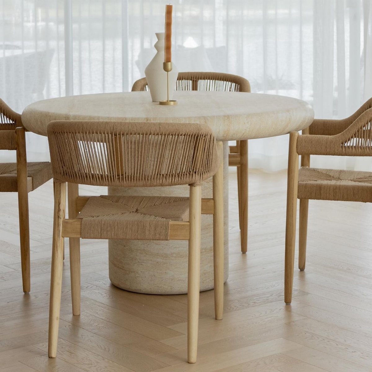 Contemporary Dining Sets in 12 Styles for Your Space 12 Round stone dining table with wooden chairs featuring woven rope seats and backs.
