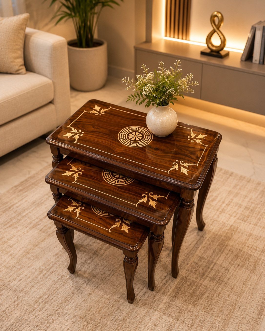 12 Space Saving Furniture Ideas That Actually Work 4 Three dark brown wooden nesting tables with gold patterns in a living room.