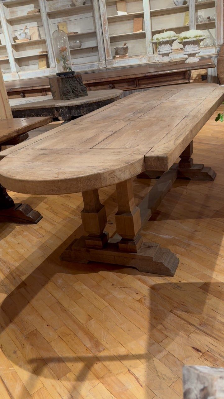20 French Farmhouse Dining Table Ideas for Every Style 12 Oval light brown wooden trestle dining table on a hardwood floor