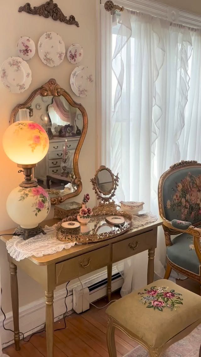 Ornate gold vanity set with floral lamp and mirror in a vintage room