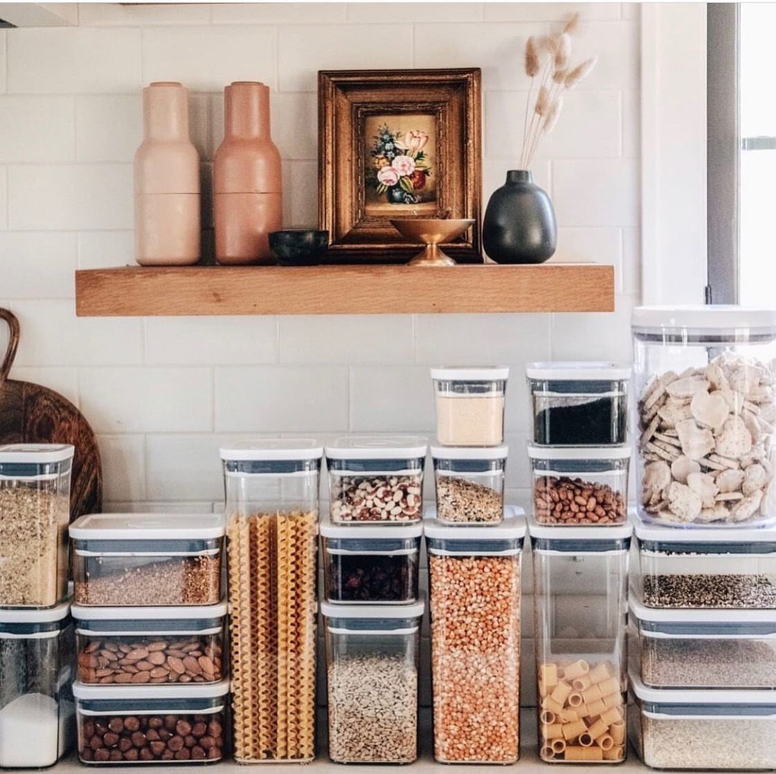10 Kitchen Storage Container Ideas for Pantry and Fridge 3 Clear plastic airtight containers filled with pantry staples on a white kitchen counter.