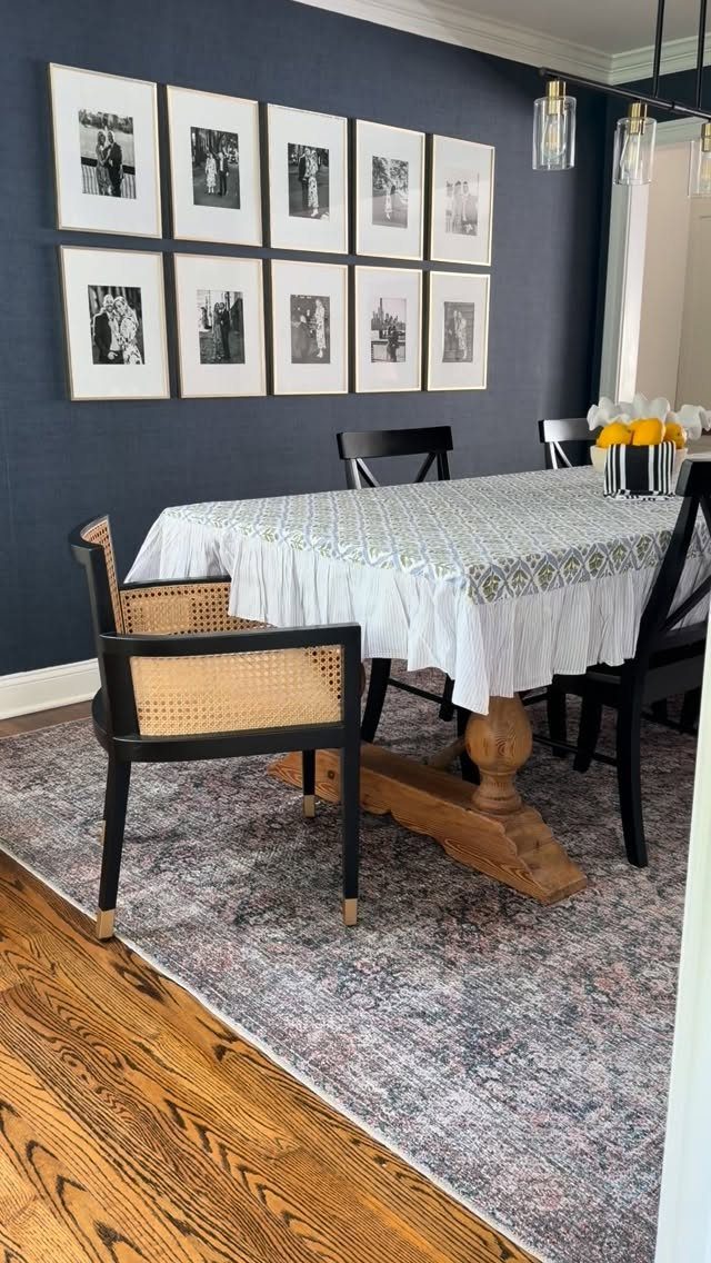 White patterned tablecloth on a wooden dining table in a room with blue walls.