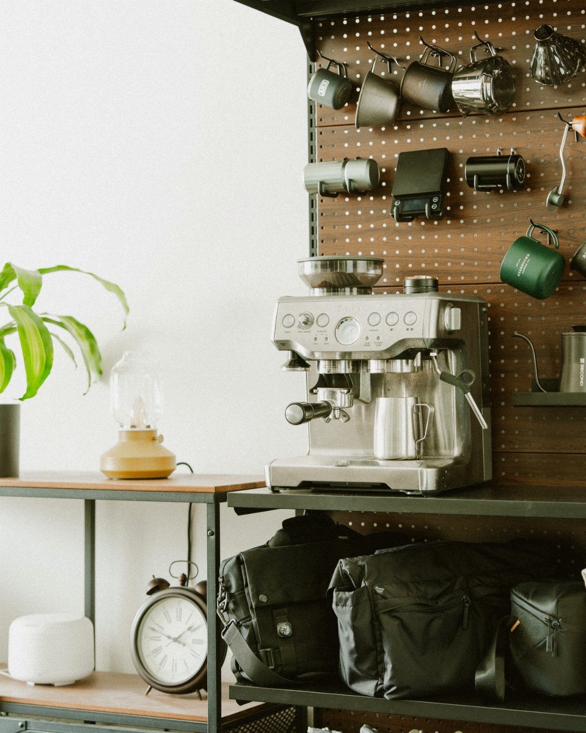 Wall Mounted Coffee Bar: 23 Stylish Space-Saving Ideas 23 Espresso machine on a shelf with a pegboard wall holding coffee mugs.