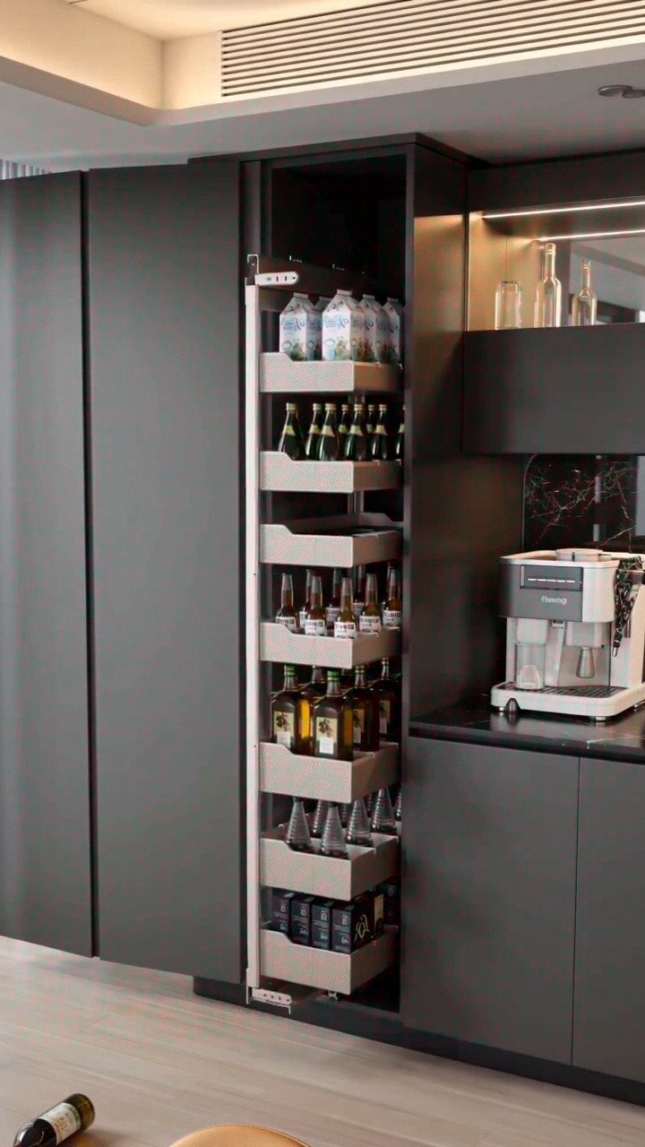 26 Pull Out Drawer Kitchen Ideas That Save Space 19 Pull-out kitchen pantry drawer filled with bottles in a modern dark grey kitchen.