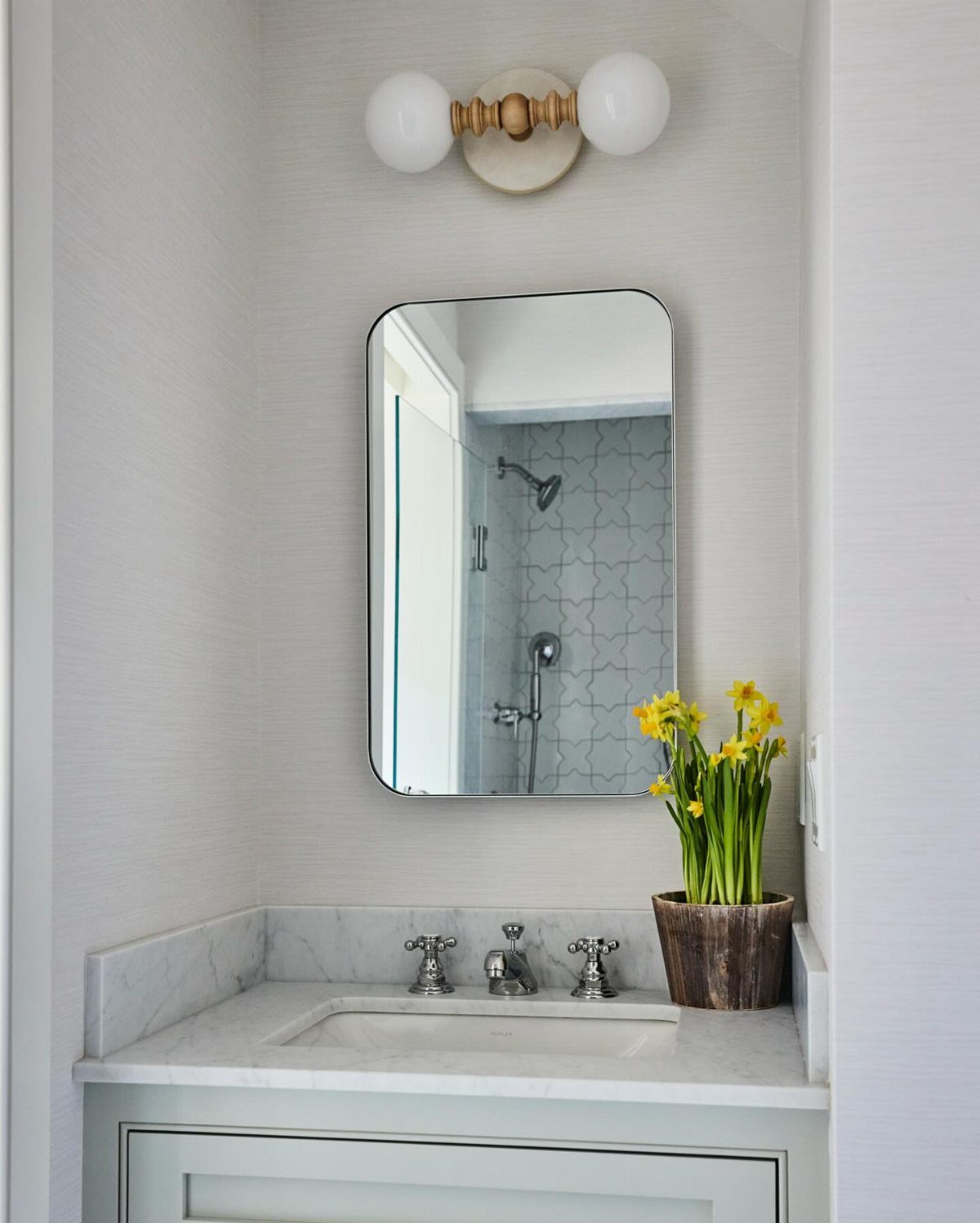 Bathroom Alcove Ideas: 29 Designs for Tubs, Showers & More 26 Bathroom vanity with marble countertop and mirror set inside a light grey alcove.
