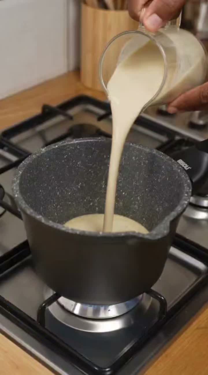 Small Kitchen Essentials: 13 Tools That Actually Matter 7 Creamy liquid being poured into a dark grey speckled saucepan on a gas stove.