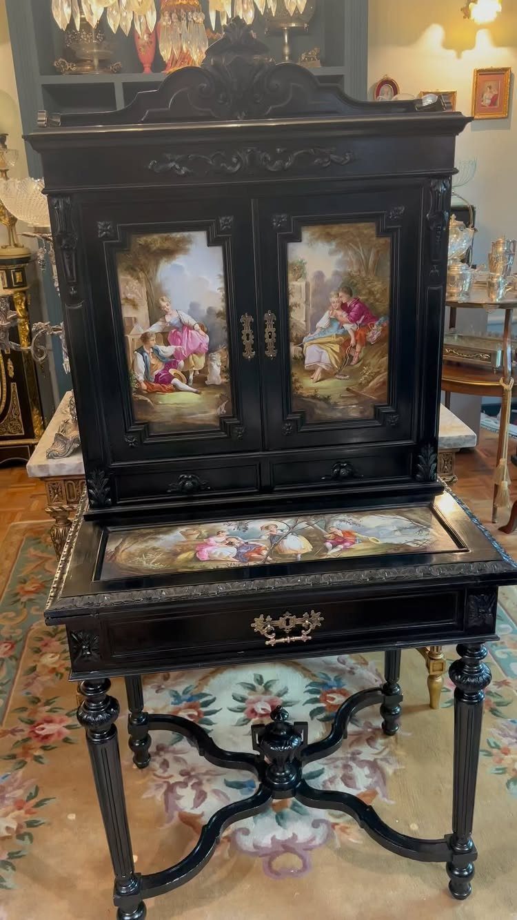 Black vintage secretary desk with a hutch featuring painted romantic scenes on the doors.