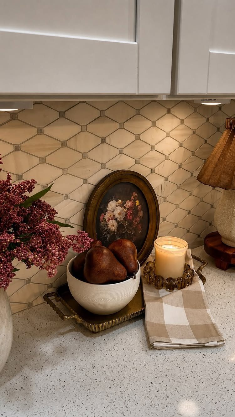 32 Simply Kitchen Design Ideas for a Clean, Modern Space 24 Kitchen counter with pears in a bowl, a candle, and floral art.