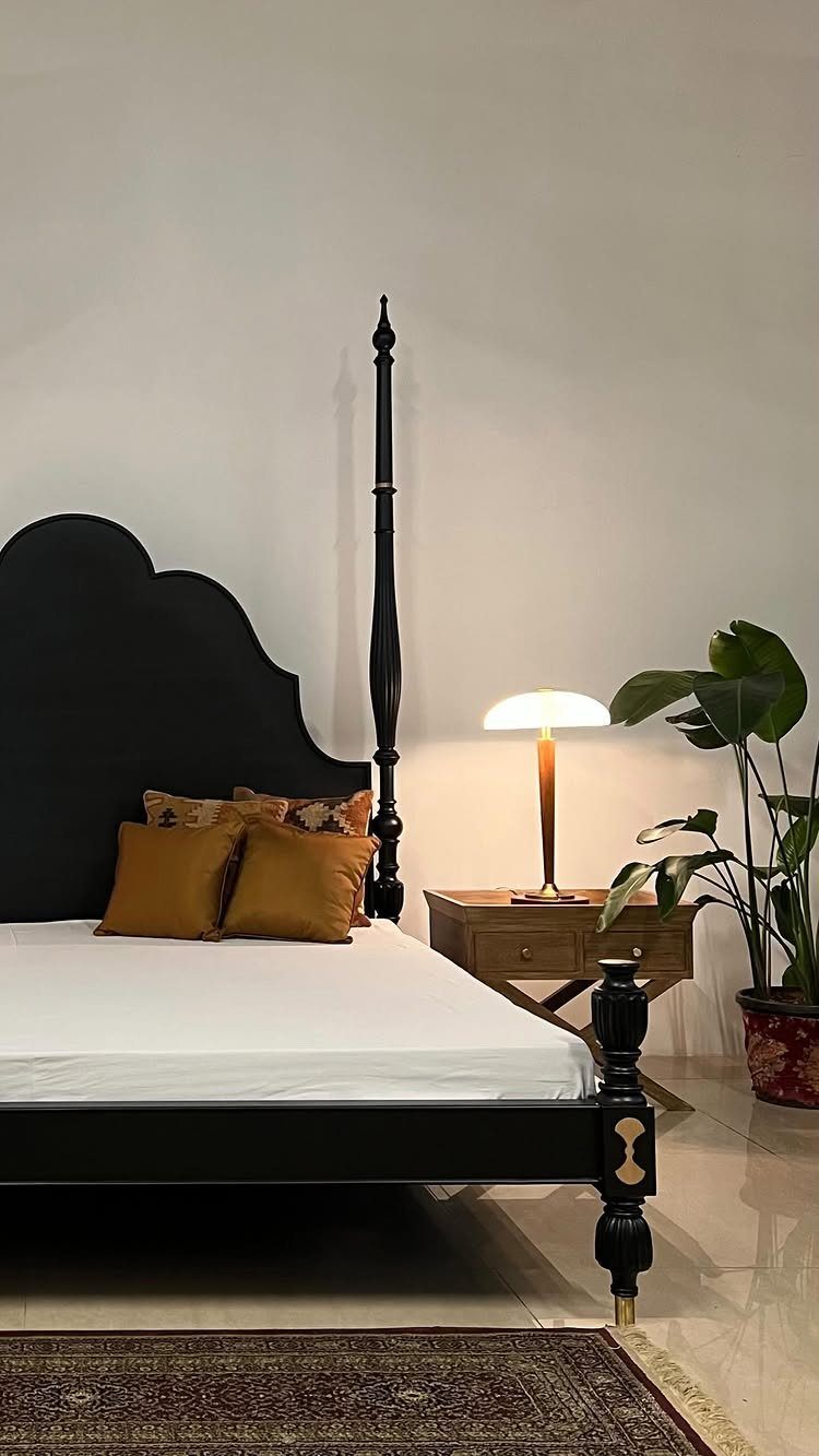 Wood Art Furniture: 31 Ideas From Rustic to Sculptural Forms 13 Black wooden bed with carved post and a small wooden nightstand with lamp.