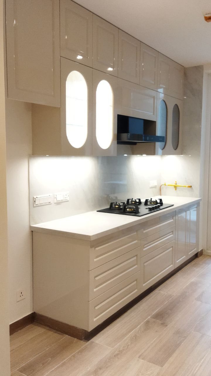 32 Simply Kitchen Design Ideas for a Clean, Modern Space 7 Beige straight kitchen with white countertops, built-in stovetop, and under-cabinet lighting.