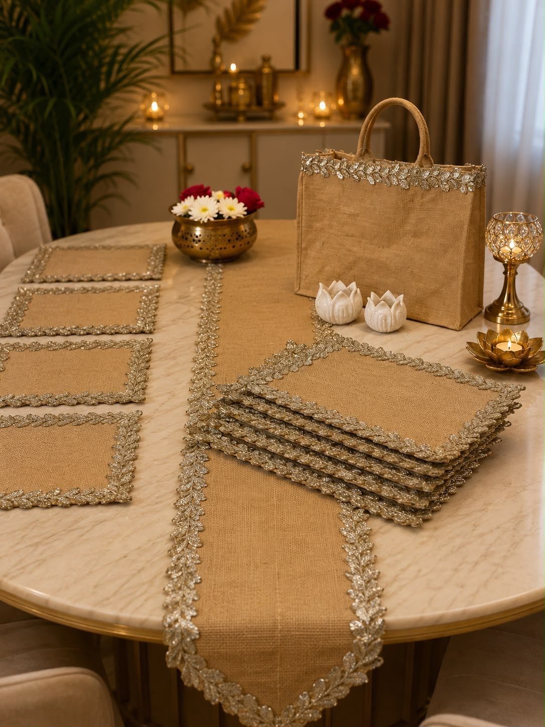 Burlap table runner with silver sequin trim on a white marble dining table.