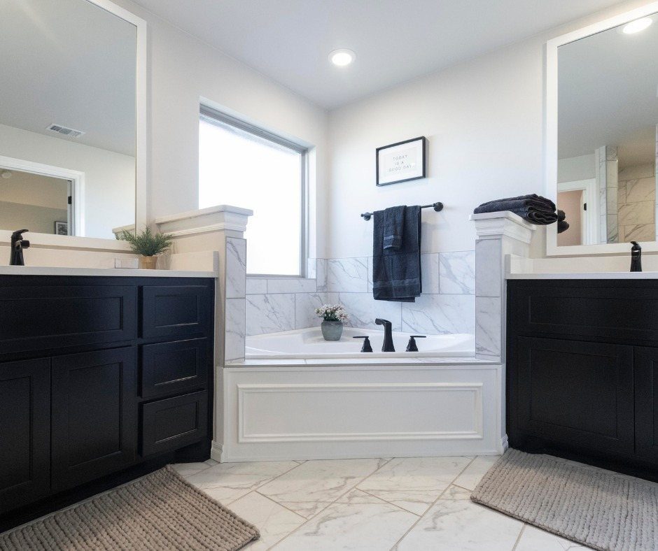 Bathroom Alcove Ideas: 29 Designs for Tubs, Showers & More 9 White built-in bathtub in a marble tile alcove between two black vanities.